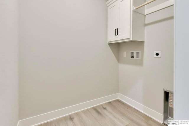 clothes washing area with cabinets, hookup for a washing machine, hookup for an electric dryer, and light wood-type flooring