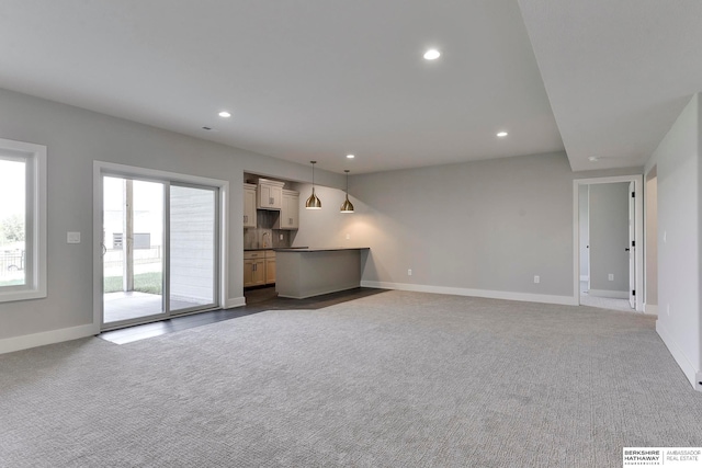 unfurnished living room featuring carpet flooring and sink