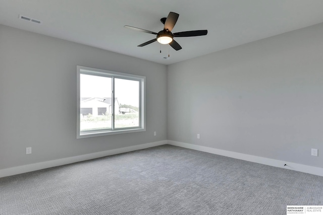 empty room featuring ceiling fan and carpet