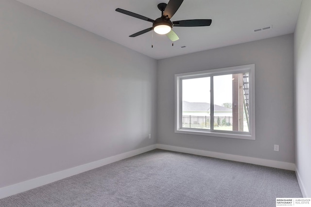 carpeted spare room with ceiling fan