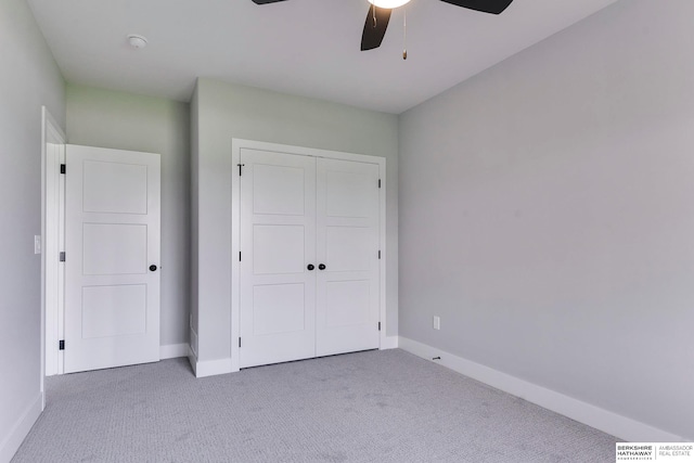 unfurnished bedroom featuring carpet flooring, ceiling fan, and a closet