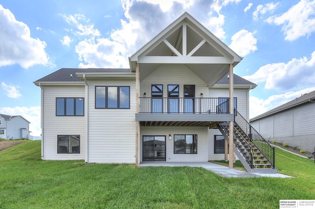 back of house featuring a patio and a yard