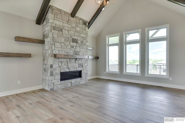 unfurnished living room featuring light hardwood / wood-style floors, plenty of natural light, and high vaulted ceiling