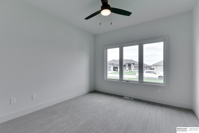 unfurnished room featuring light colored carpet and ceiling fan