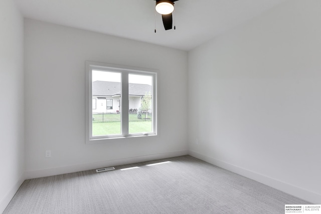 unfurnished room with ceiling fan and carpet floors