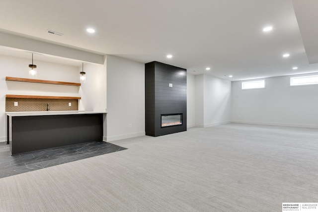 basement featuring a fireplace and carpet floors