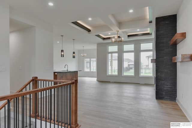 interior space featuring a wealth of natural light, beamed ceiling, light hardwood / wood-style flooring, and coffered ceiling