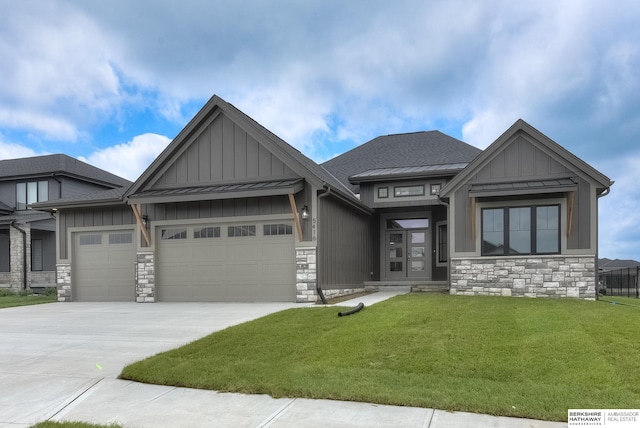 view of front of house with a garage and a front lawn