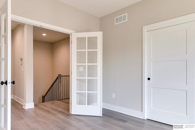 unfurnished room with light wood-type flooring