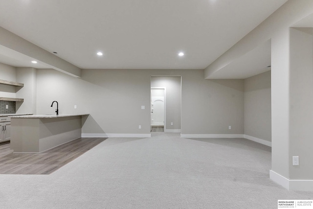 interior space with light carpet and sink