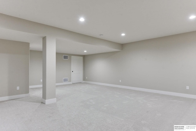 basement featuring light carpet