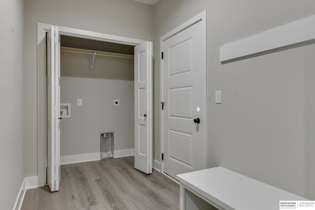 laundry room with hookup for a washing machine, electric dryer hookup, and light hardwood / wood-style flooring