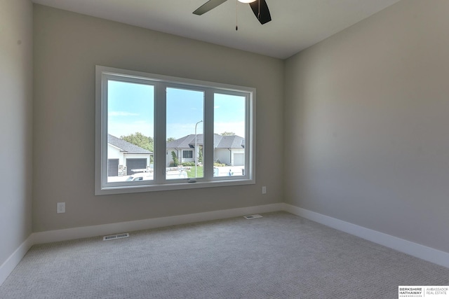 carpeted spare room with ceiling fan