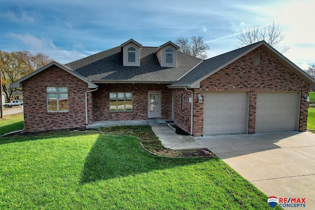 view of front of home with a garage and a front lawn