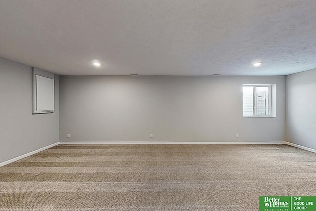 spare room with carpet flooring and a textured ceiling