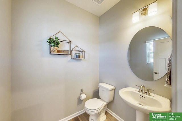 bathroom with wood-type flooring, sink, and toilet