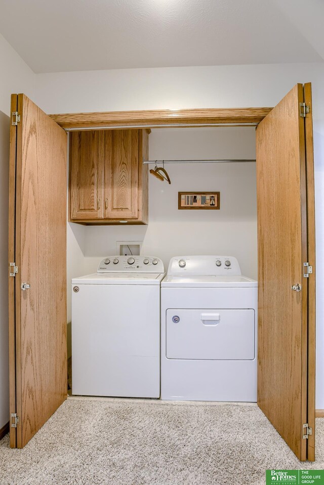 laundry area featuring cabinets, carpet flooring, and washing machine and clothes dryer