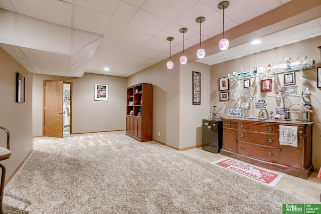 bar with a drop ceiling, light carpet, and decorative light fixtures