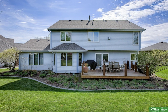 rear view of property featuring a wooden deck and a yard