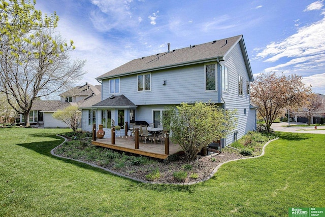 back of house with a lawn and a wooden deck