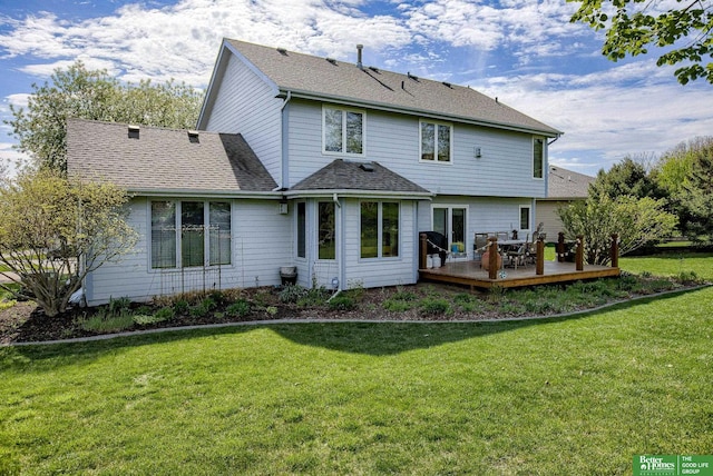 rear view of house with a wooden deck and a yard