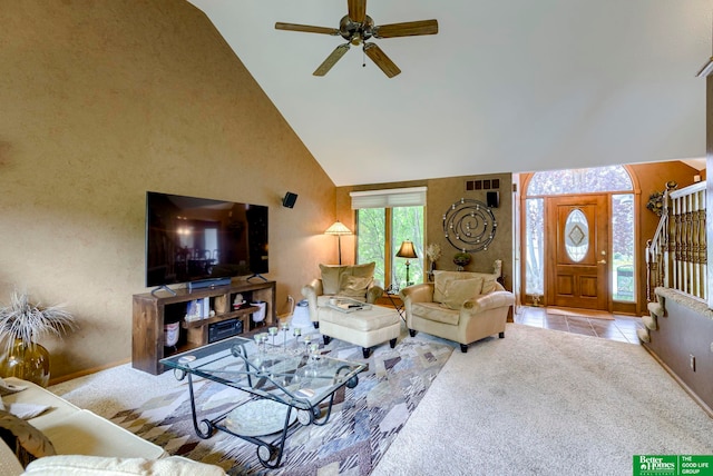 carpeted living room featuring high vaulted ceiling and ceiling fan