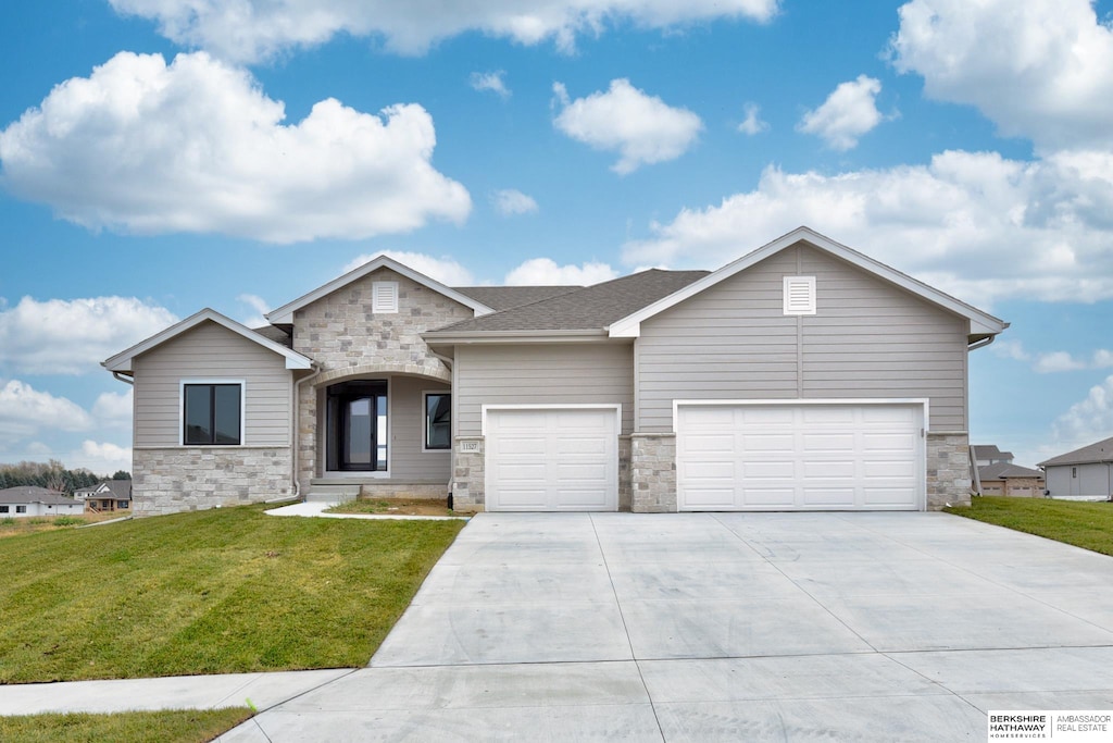 view of front facade with a garage and a front lawn