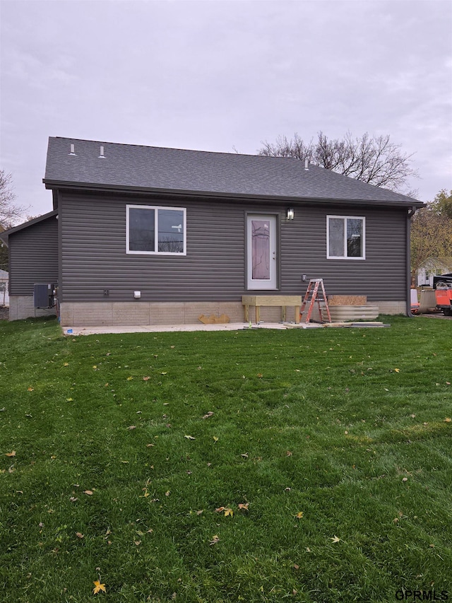 rear view of property featuring a patio area, a lawn, and cooling unit