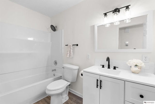 full bathroom with wood-type flooring, toilet, decorative backsplash, vanity, and bathing tub / shower combination