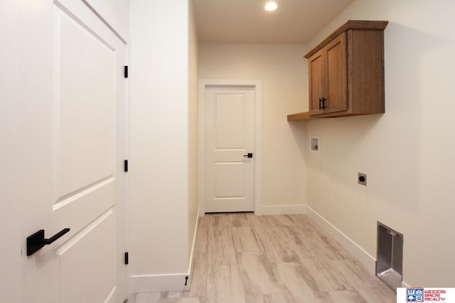 washroom featuring cabinets, electric dryer hookup, washer hookup, and light wood-type flooring