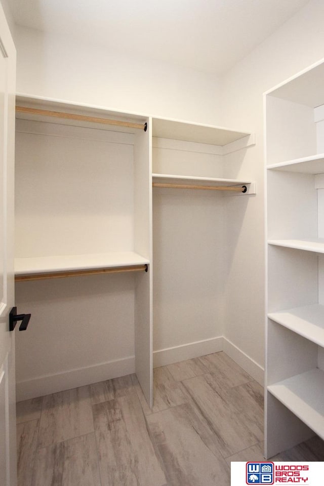 spacious closet featuring light hardwood / wood-style flooring