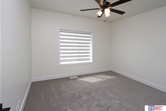 empty room with dark colored carpet and ceiling fan