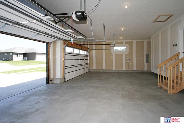 garage with electric panel and a garage door opener