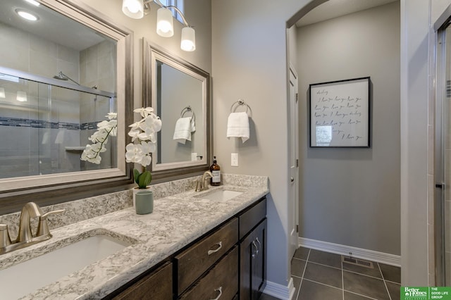 bathroom with vanity, an enclosed shower, and tile patterned flooring