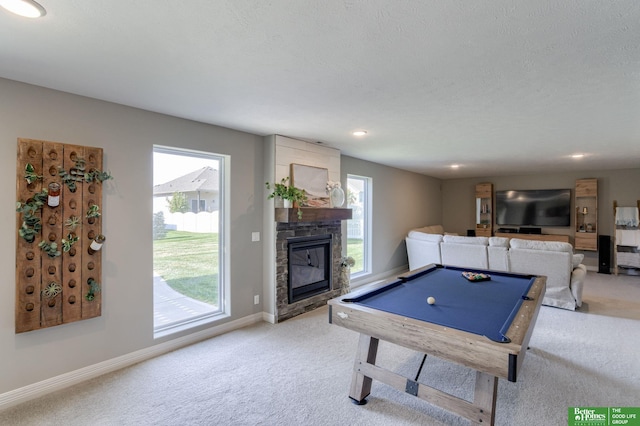 playroom featuring billiards, a fireplace, a textured ceiling, and carpet