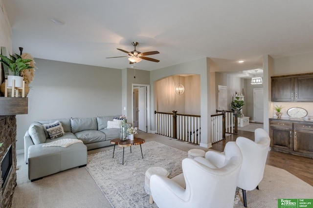 living room featuring ceiling fan and light hardwood / wood-style flooring