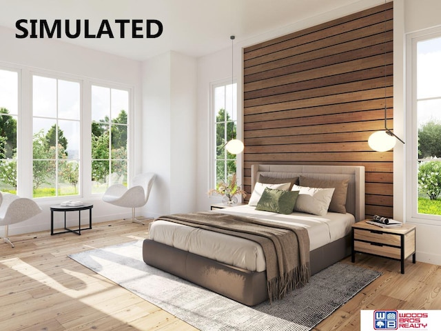 bedroom featuring multiple windows and light wood-type flooring