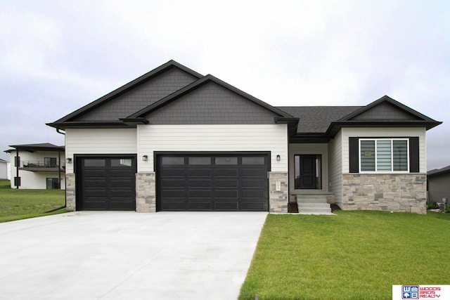 craftsman-style house featuring a garage and a front lawn