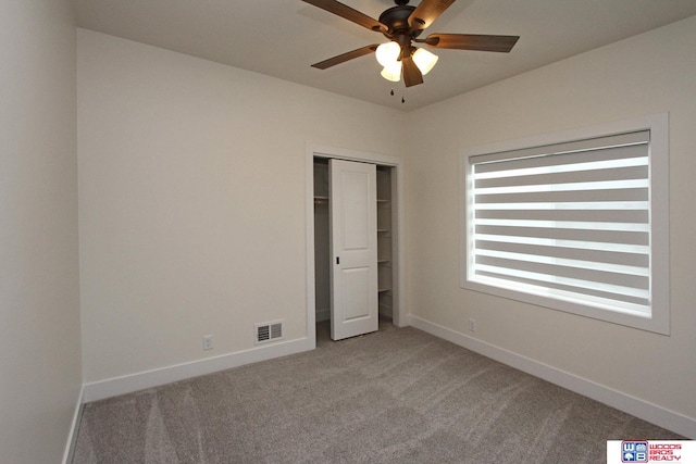 unfurnished bedroom with light colored carpet and ceiling fan