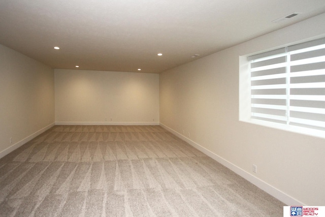 unfurnished room with light colored carpet