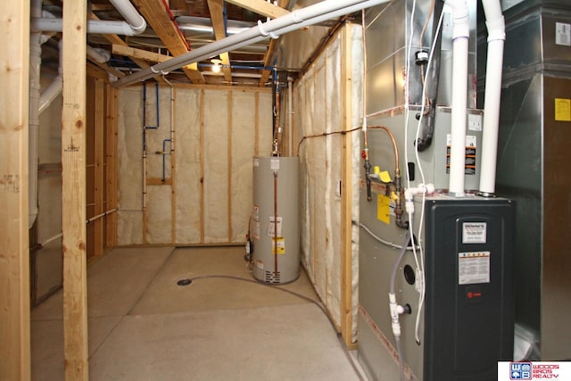 utility room featuring water heater and heating unit