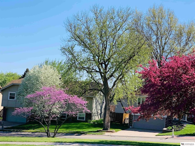 view of front facade with a garage and a front yard