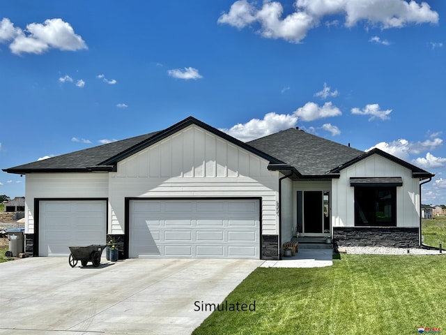 view of front of property featuring a garage and a front lawn