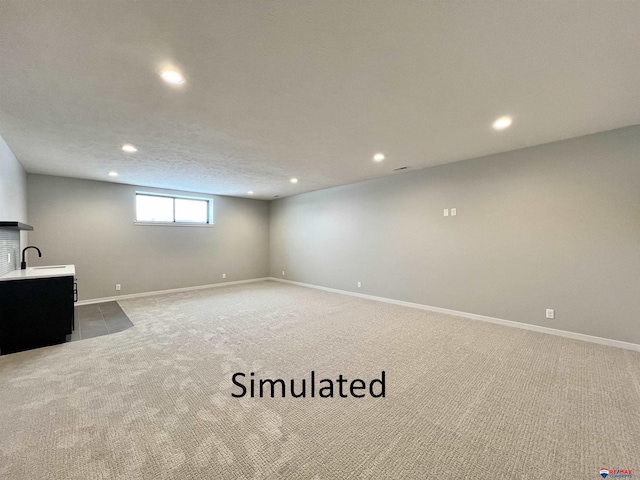 basement with carpet floors and sink