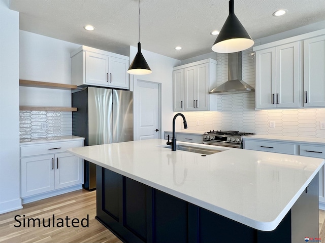 kitchen with sink, wall chimney range hood, tasteful backsplash, and hanging light fixtures