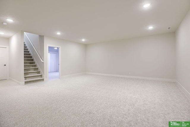 basement featuring light colored carpet