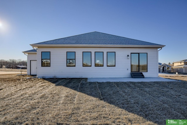 rear view of property with a yard and a patio