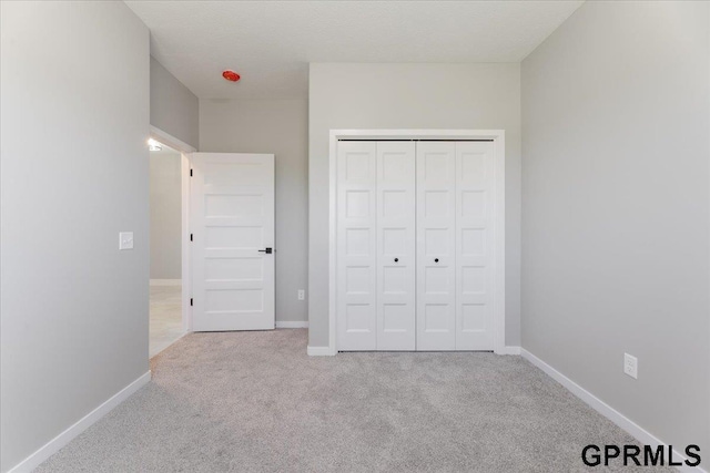 216 St Andrews Loop, Malvern, IA 51551 - unfurnished bedroom featuring carpet floors, baseboards, and a closet