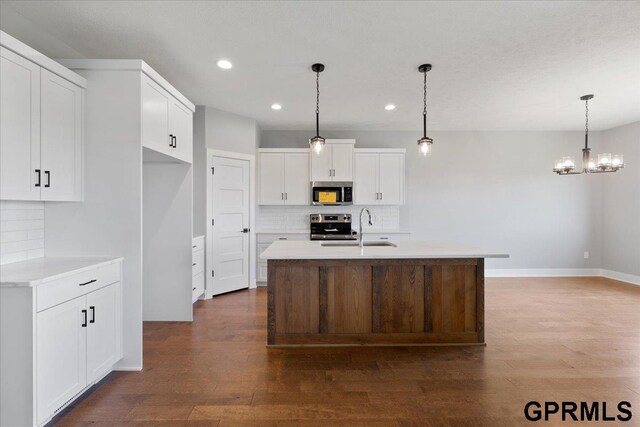 216 St Andrews Loop, Malvern, IA 51551 - kitchen featuring appliances with stainless steel finishes, tasteful backsplash, a sink, recessed lighting, and white cabinets
