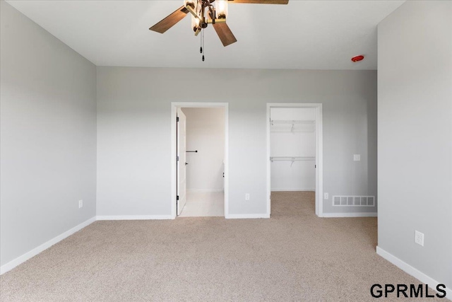216 St Andrews Loop, Malvern, IA 51551 - unfurnished bedroom featuring carpet floors, a walk in closet, baseboards, and a closet